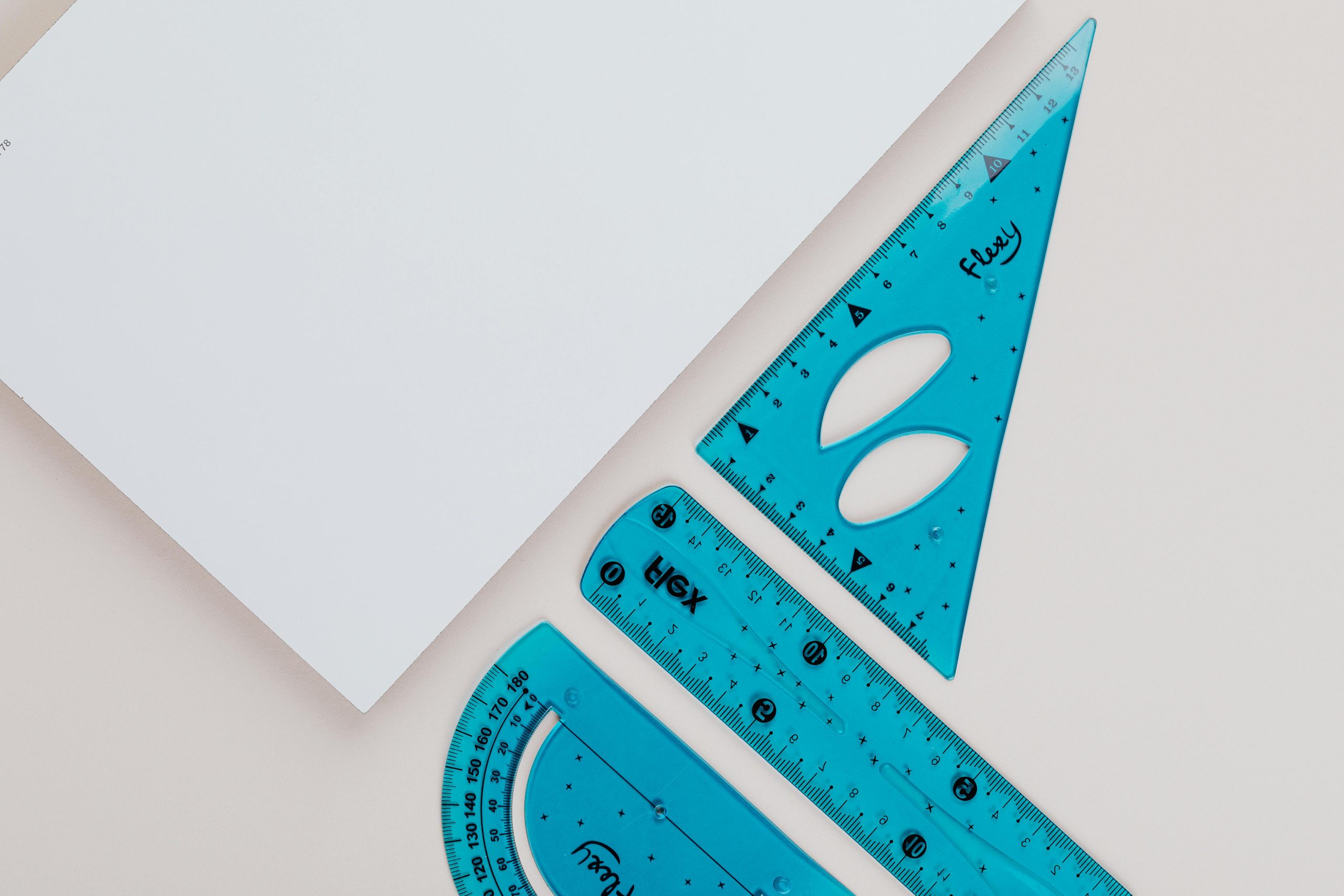 Close-up image of blue geometry tools on white background for educational use.